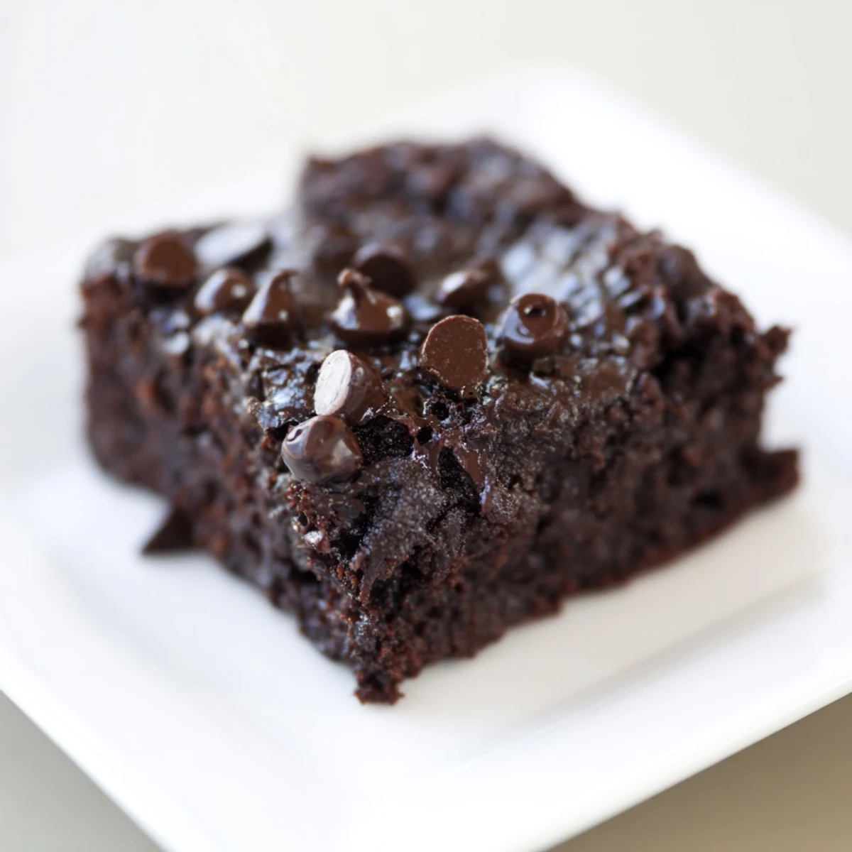 Fudgy Greek yogurt brownies, warm from the oven, with melting chocolate chips and a delightful aroma.