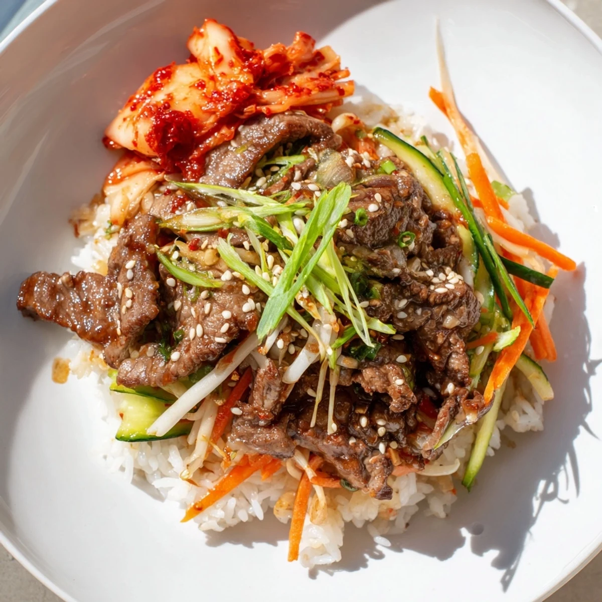 Tender, glistening Bulgogi Beef Bowl featuring tender beef, vegetables, and rice; a delicious Korean-inspired meal.