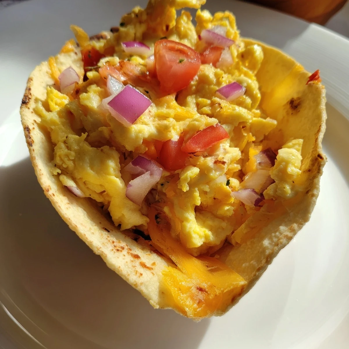 Golden brown Sheet Pan Breakfast Tacos with diced tomatoes, onions, and peppers, served hot from the oven.