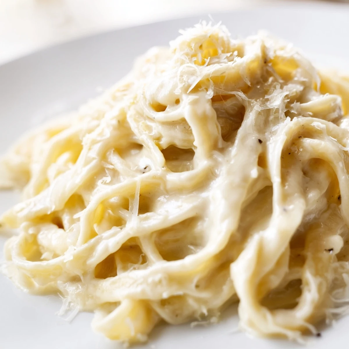 Steaming Roasted Garlic Cream Pasta in a skillet, featuring al dente noodles tossed in a luscious roasted garlic cream sauce.
