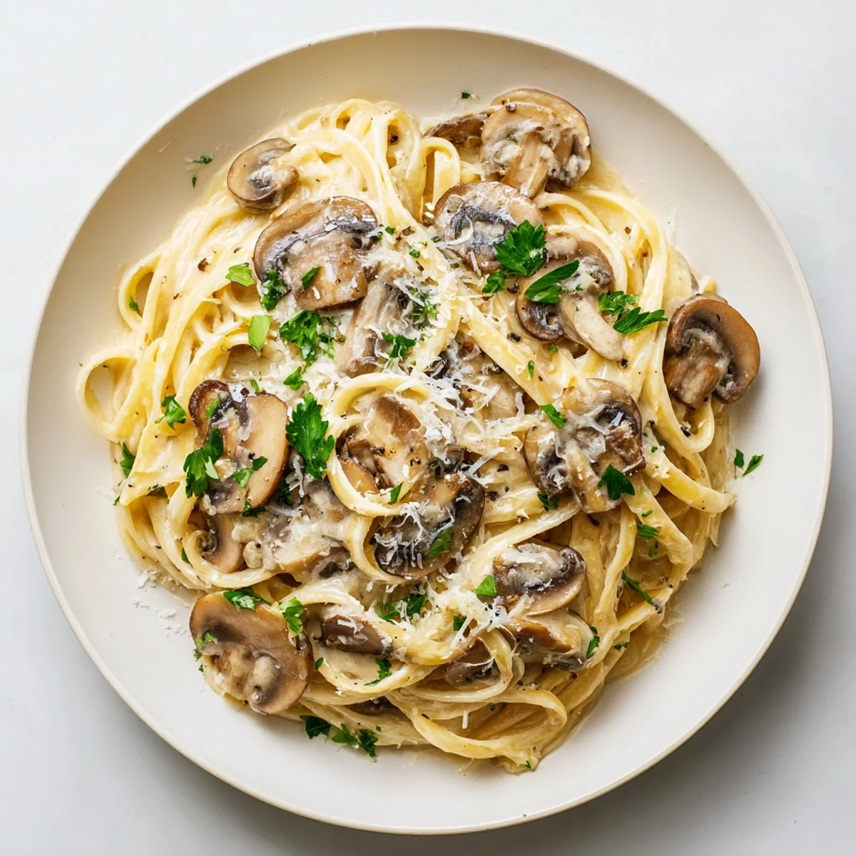 Creamy Mushroom Alfredo pasta with golden sautéed mushrooms and fresh parsley garnish.  
