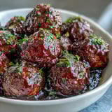 A platter of sweet and tangy Grape Jelly and Chili Sauce Meatballs, served with toothpicks for easy entertaining.