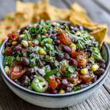 Ready to serve Cowboy Caviar dip with crunchy tortilla chips for a party appetizer.