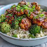 A close-up of Sweet and Spicy Turkey Broccoli Bowls featuring tender ground turkey, crisp green onion, and glossy sauce over fluffy rice. 