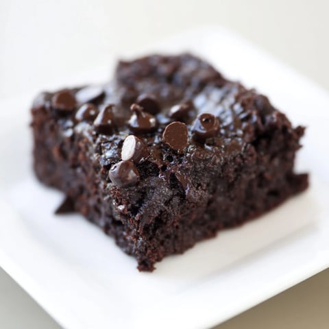 Fudgy Greek yogurt brownies, warm from the oven, with melting chocolate chips and a delightful aroma.