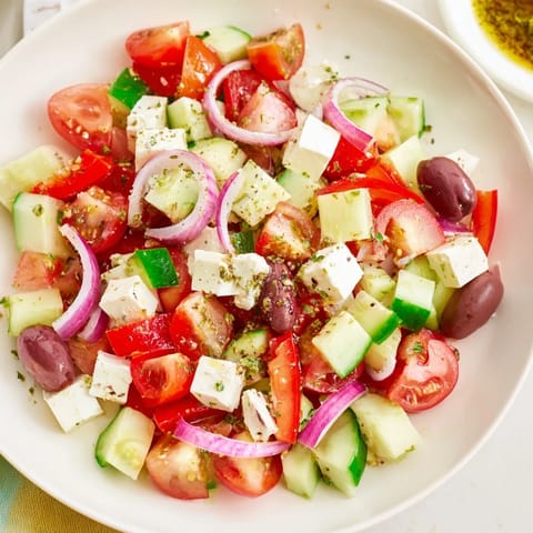 A bright bowl showcasing Fresh Mediterranean Salad bursting with flavors of olives and lemon dressing.