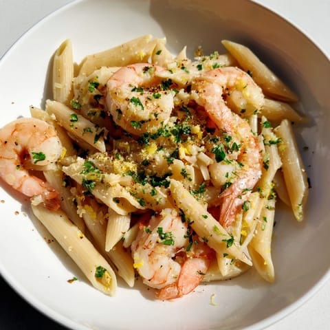 A close-up of perfectly cooked Garlic Shrimp Penne, vibrant and full of savory flavor.