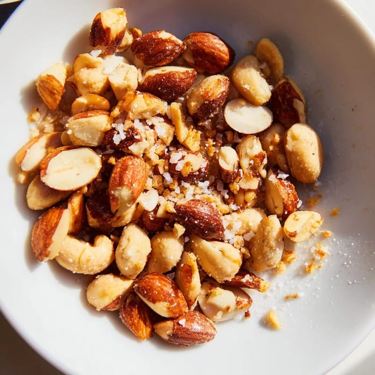Close-up of perfectly roasted Simple Garlic-Honey Pecans, showcasing a delightful mix of sweet, salty, and aromatic flavors.
