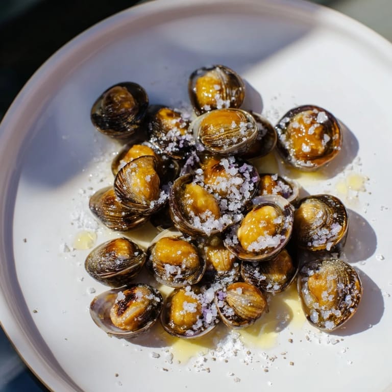 Warm, toasted Simple Garlic-Honey Roasted Pecans—the recipe's finished product, perfect for snacking or holiday gatherings.
