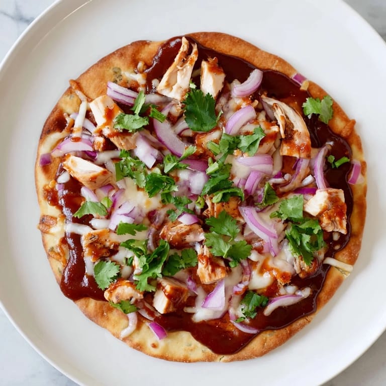 Perfectly sliced BBQ Chicken Flatbread wedges served on a wooden board, ready for a quick weeknight dinner or casual party appetizer platter.
