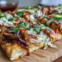 Smoky BBQ chicken flatbread pizza with melty mozzarella, red onions, and cilantro—perfect for summer grilling nights.  